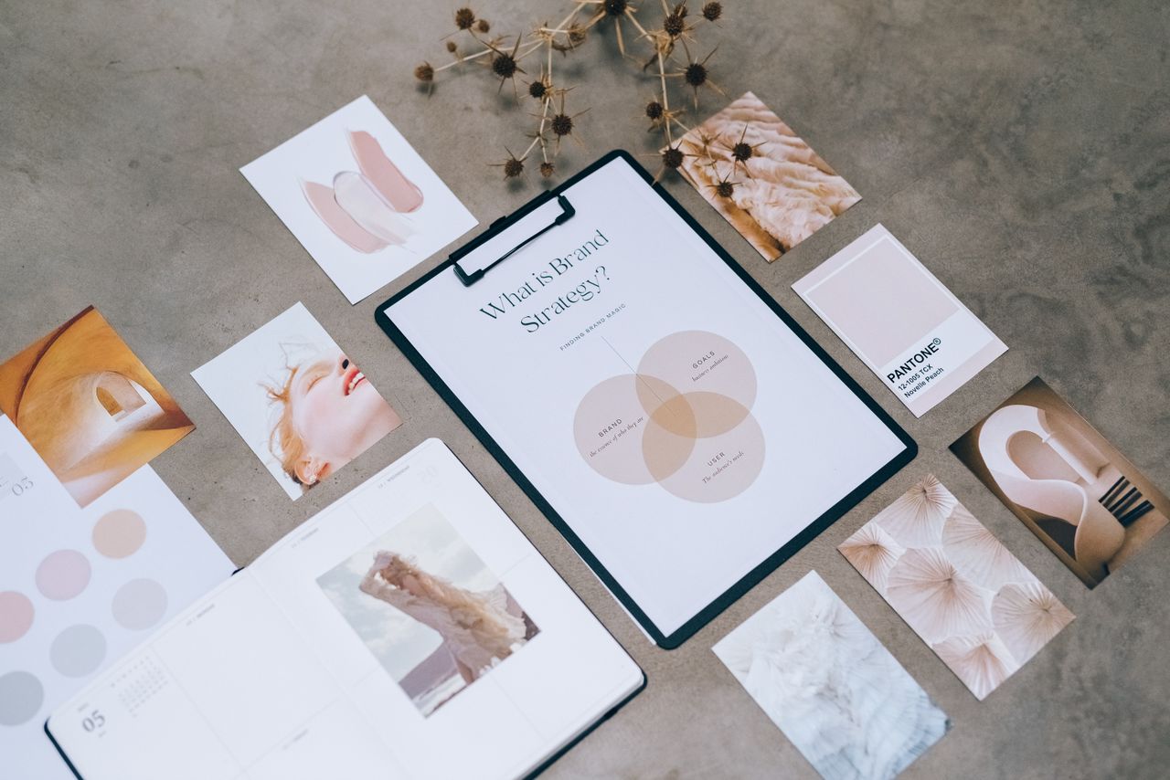 services-02 Flat lay of a minimalist brand strategy moodboard on a concrete surface.